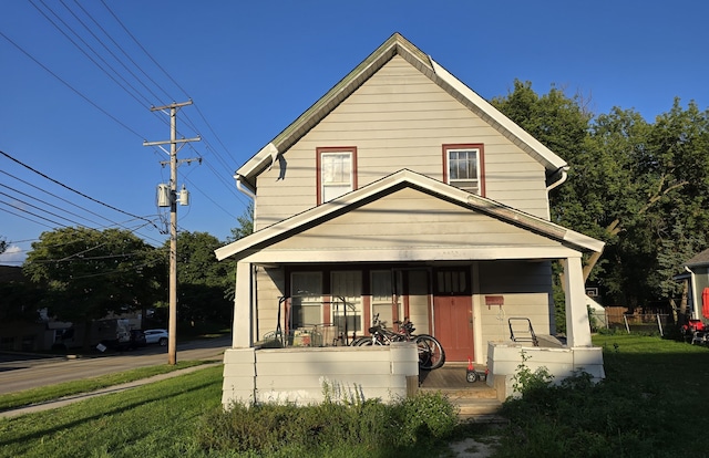 view of front facade featuring a front lawn and covered porch