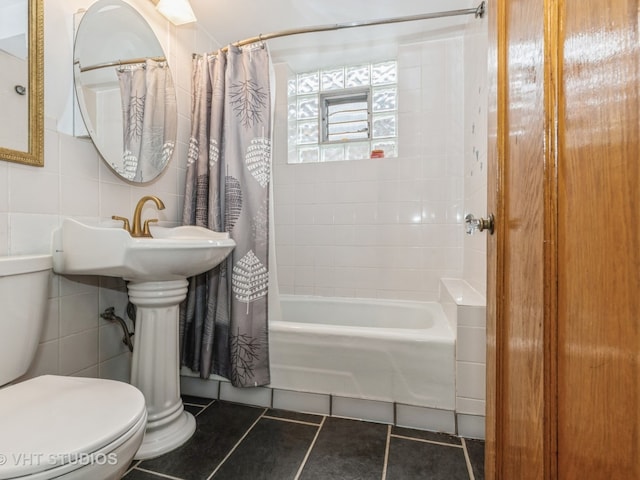 bathroom featuring tile walls, tile patterned flooring, shower / bath combination with curtain, and toilet