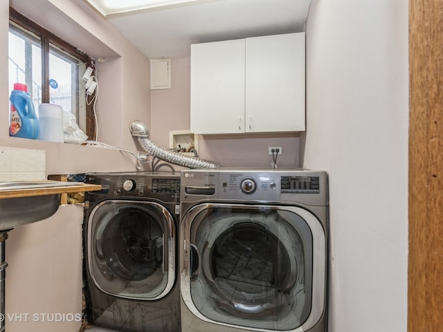 clothes washing area with independent washer and dryer and cabinets