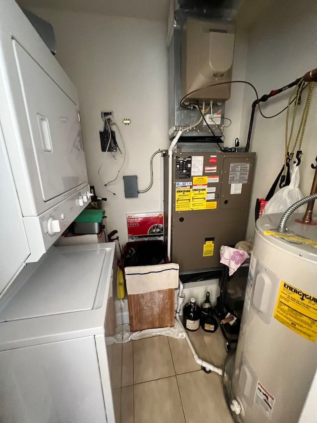 utilities with stacked washer and dryer and water heater