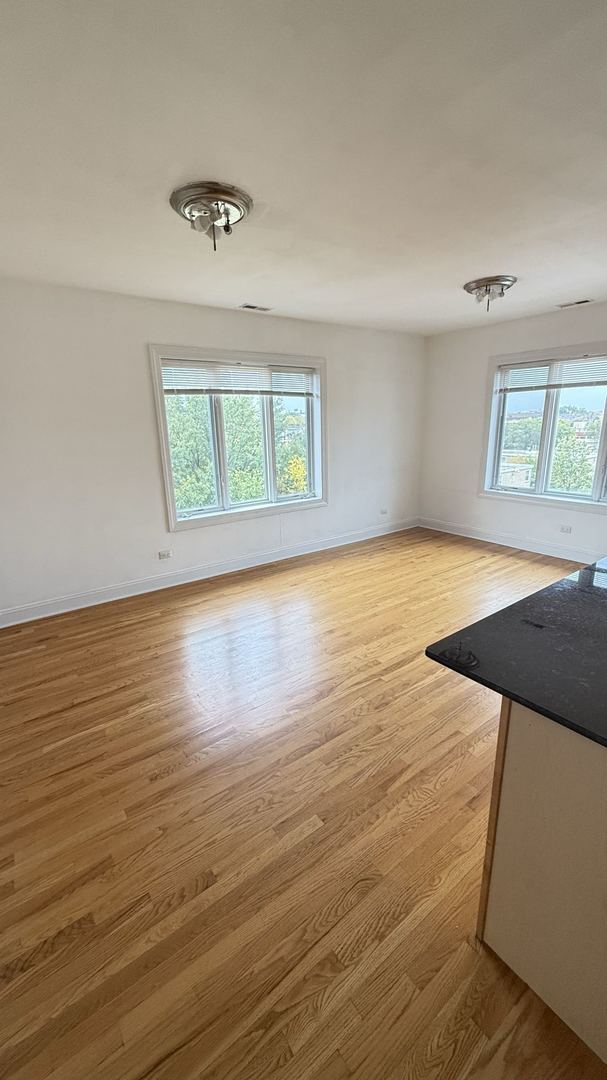 unfurnished living room with a wealth of natural light and light hardwood / wood-style floors