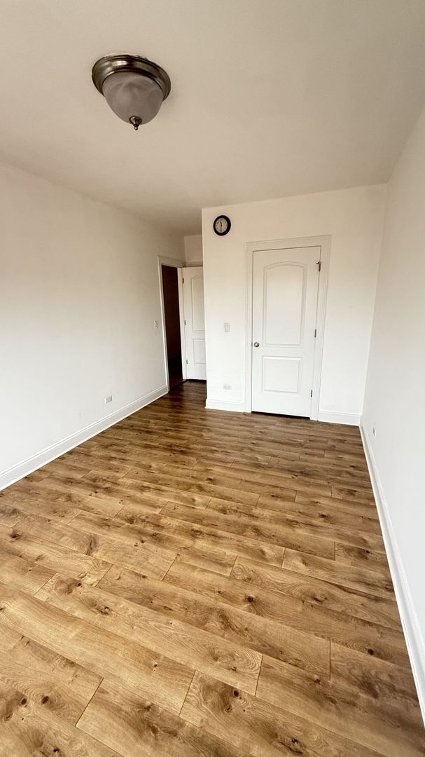 unfurnished room with hardwood / wood-style floors