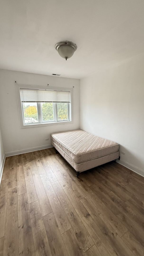 unfurnished bedroom with hardwood / wood-style floors