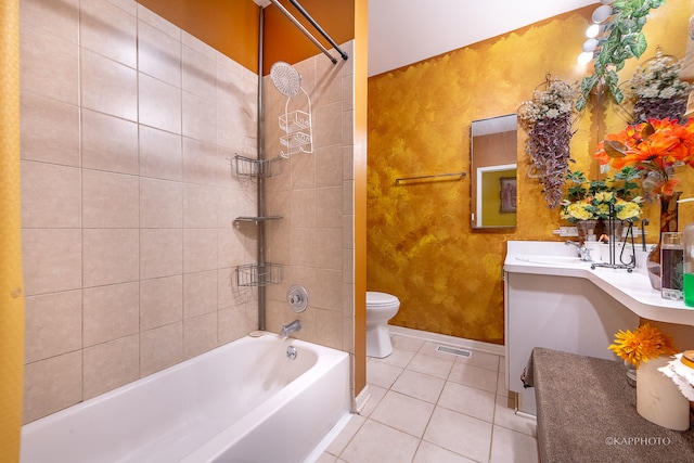 full bathroom featuring tile patterned floors, vanity, tiled shower / bath combo, and toilet