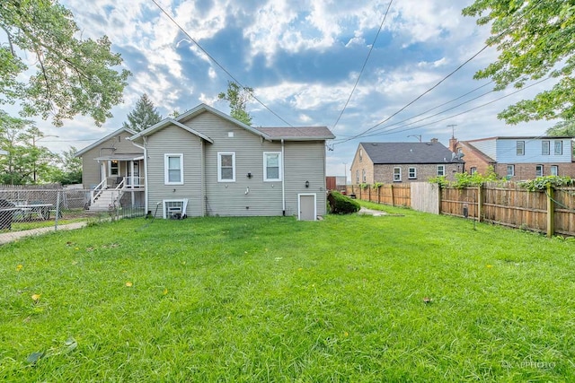 rear view of house with a yard