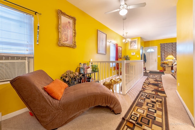 interior space featuring carpet, plenty of natural light, and ceiling fan with notable chandelier