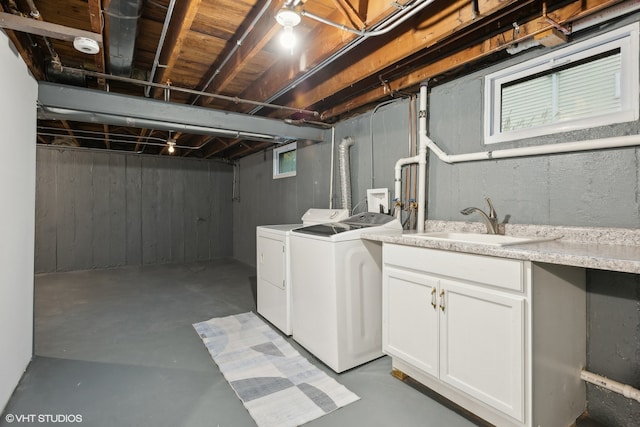 laundry room with cabinets, separate washer and dryer, and sink