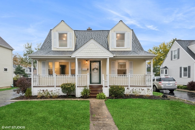 view of front of property with a porch and a front lawn