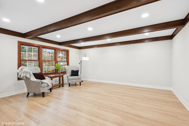 sitting room featuring light hardwood / wood-style flooring and beamed ceiling