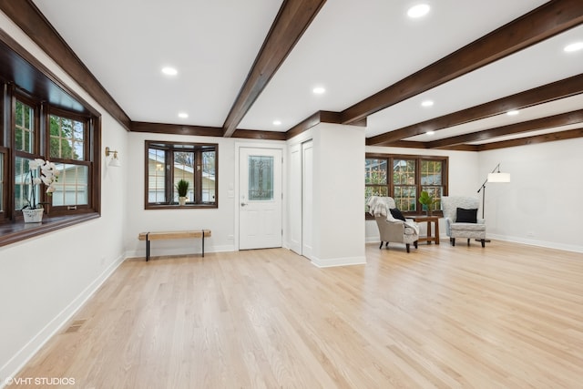 entryway with beamed ceiling and light hardwood / wood-style flooring