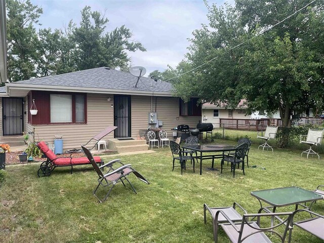 rear view of house with a lawn