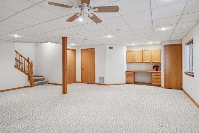 21144 W Buckeye Ct, Plainfield, IL 60544 - unfurnished living room with stairs, built in study area, a paneled ceiling, light carpet, and recessed lighting