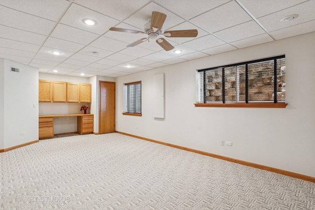 21144 W Buckeye Ct, Plainfield, IL 60544 - unfurnished living room with built in desk, light carpet, ceiling fan, a paneled ceiling, and recessed lighting