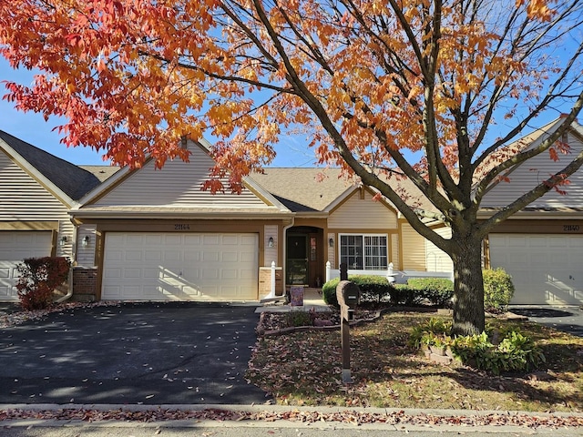 21144 W Buckeye Ct, Plainfield, IL 60544 - view of front of home with brick siding, an attached garage, and asphalt driveway