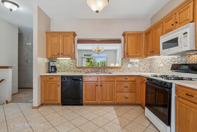 21144 W Buckeye Ct, Plainfield, IL 60544 - kitchen with white microwave, gas range, black dishwasher, light countertops, and decorative backsplash