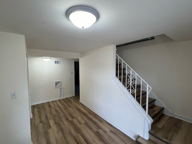 stairway with hardwood / wood-style flooring