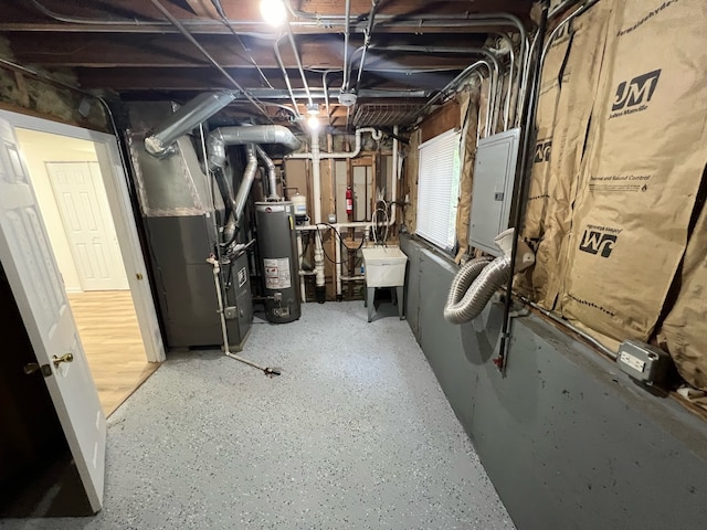 basement featuring electric panel, heating unit, gas water heater, and sink