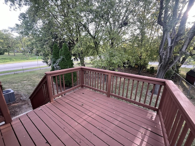 wooden terrace featuring a yard and central AC unit