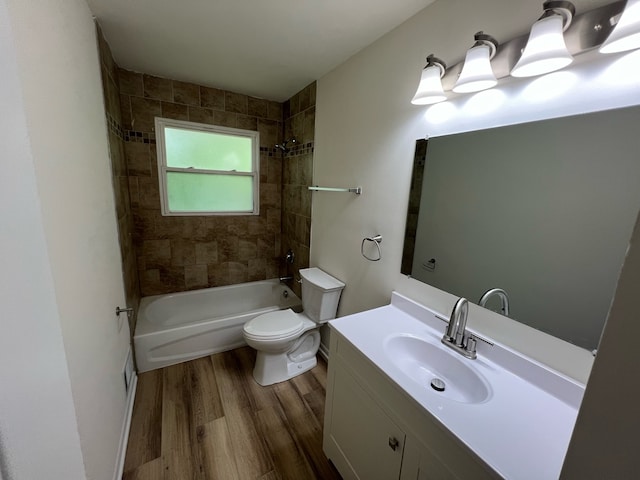 full bathroom featuring wood-type flooring, vanity, toilet, and tiled shower / bath