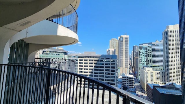 balcony with a view of city and visible vents