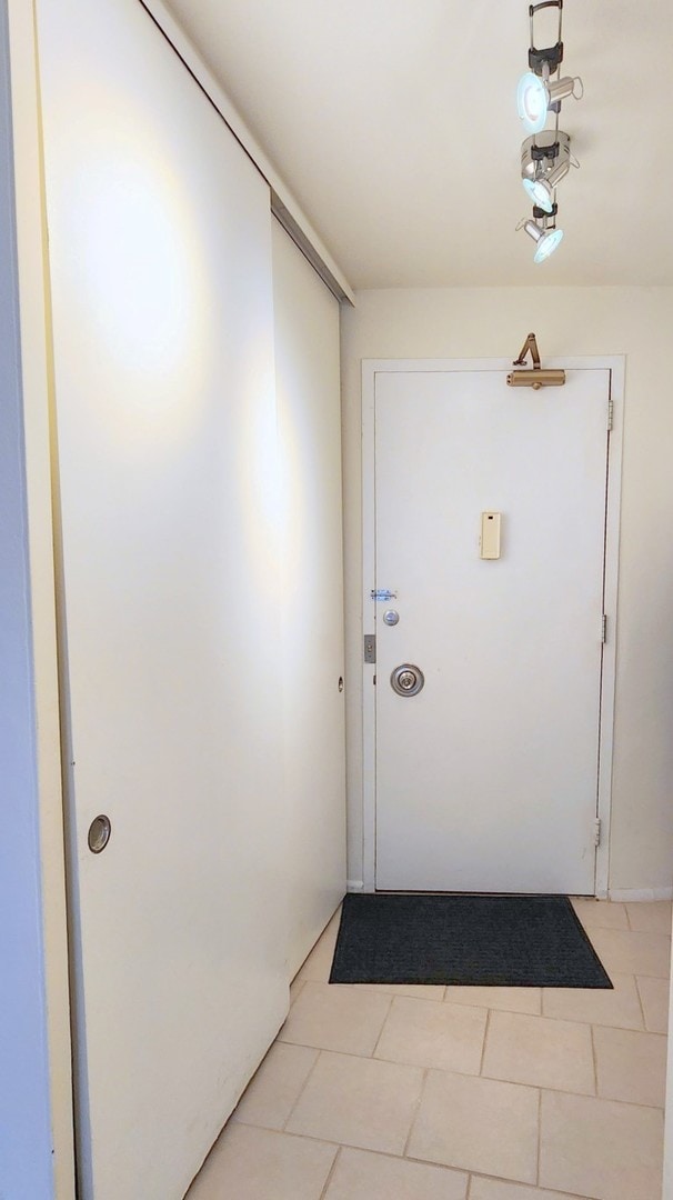 doorway to outside featuring light tile patterned floors