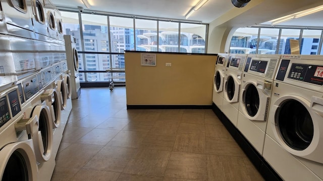 washroom featuring stacked washer and clothes dryer, independent washer and dryer, and tile patterned floors