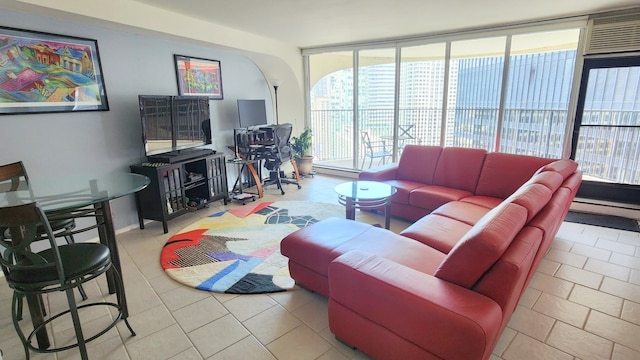 tiled living room featuring floor to ceiling windows