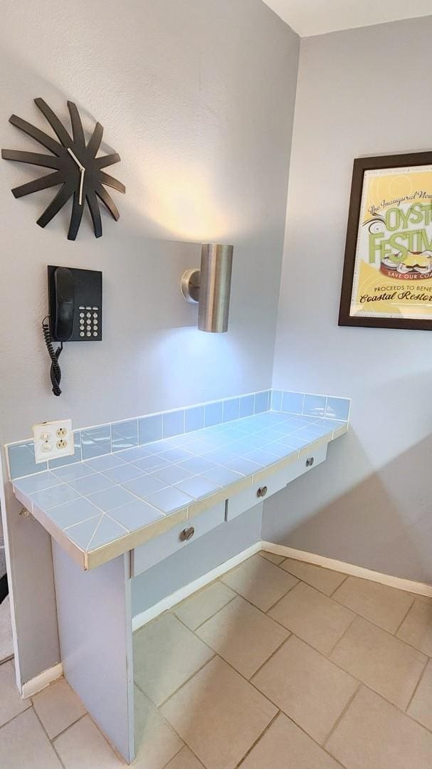 bathroom featuring baseboards and tile patterned floors