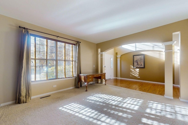 spare room featuring ornate columns