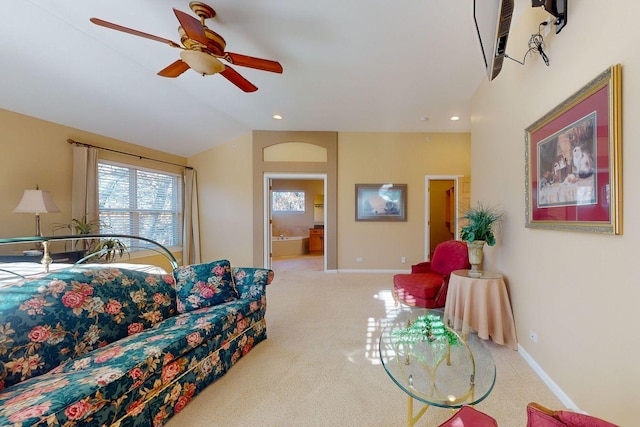 carpeted living room with lofted ceiling and ceiling fan