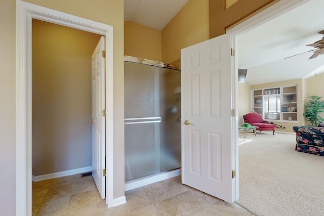 bathroom with lofted ceiling, built in shelves, and ceiling fan