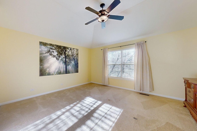 carpeted spare room featuring ceiling fan and lofted ceiling