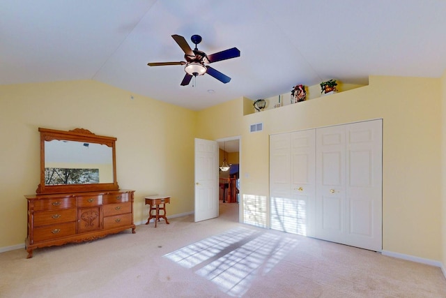 carpeted bedroom with ceiling fan, high vaulted ceiling, and a closet