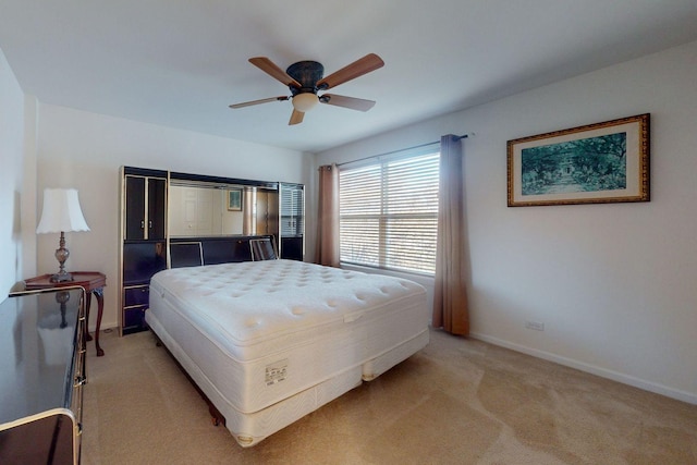 bedroom with light colored carpet and ceiling fan