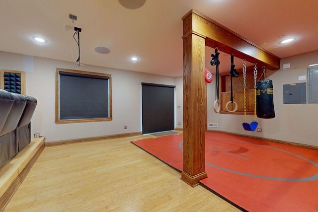 exercise area with wood-type flooring and electric panel