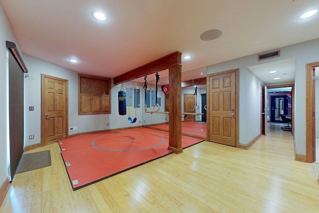 exercise room featuring light hardwood / wood-style flooring