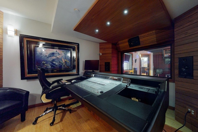 playroom featuring light hardwood / wood-style flooring, wood ceiling, wooden walls, and lofted ceiling