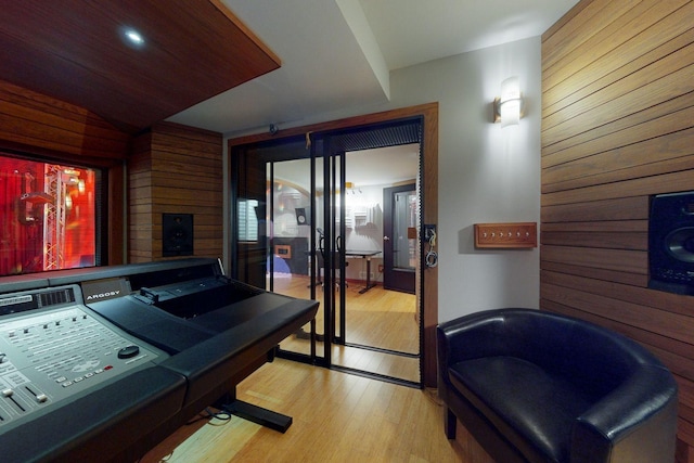 interior space with wooden walls and light hardwood / wood-style floors