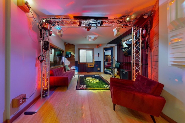 playroom with hardwood / wood-style floors and wooden walls