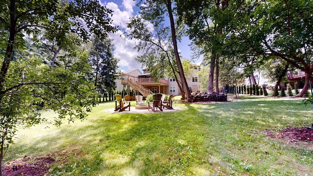 view of yard with a wooden deck and an outdoor fire pit