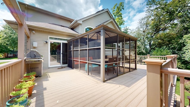 deck with a sunroom and a grill