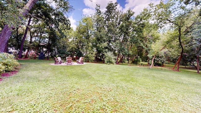 view of yard with an outdoor fire pit