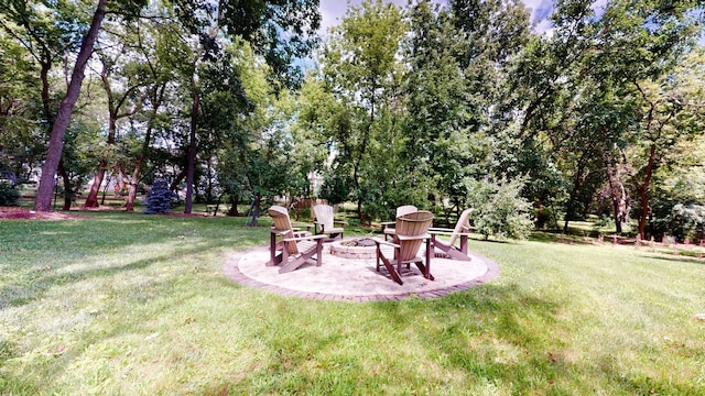 view of yard featuring a fire pit and a patio area