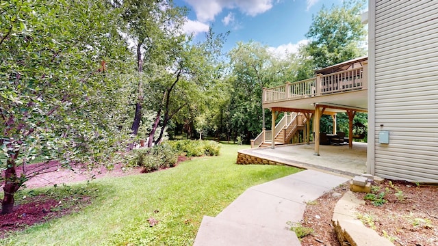 view of yard with a wooden deck and a patio area