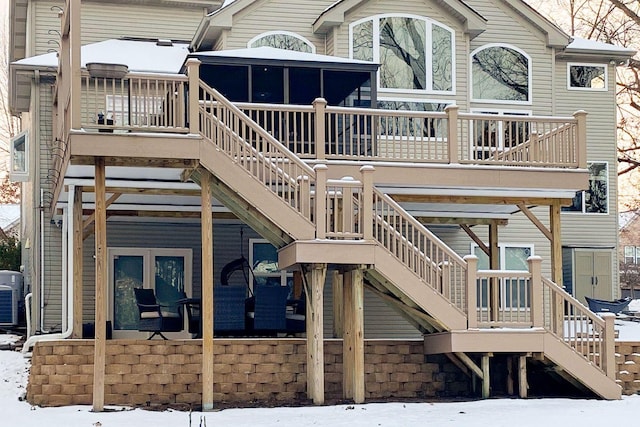 snow covered property with central AC