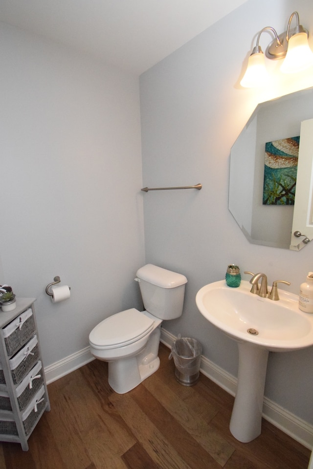 bathroom with sink, toilet, and hardwood / wood-style floors