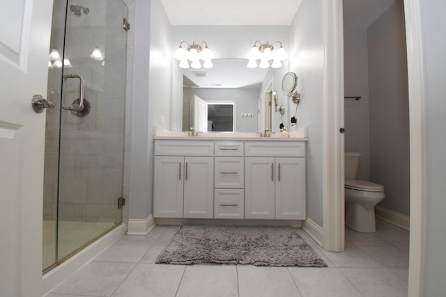 bathroom featuring a shower with shower door, tile patterned floors, dual vanity, and toilet