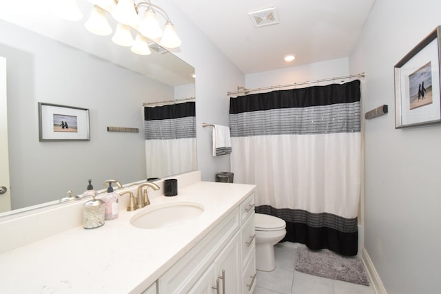 bathroom with vanity, tile patterned flooring, and toilet