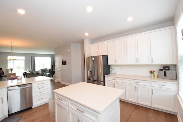 kitchen featuring appliances with stainless steel finishes, white cabinets, and light hardwood / wood-style floors