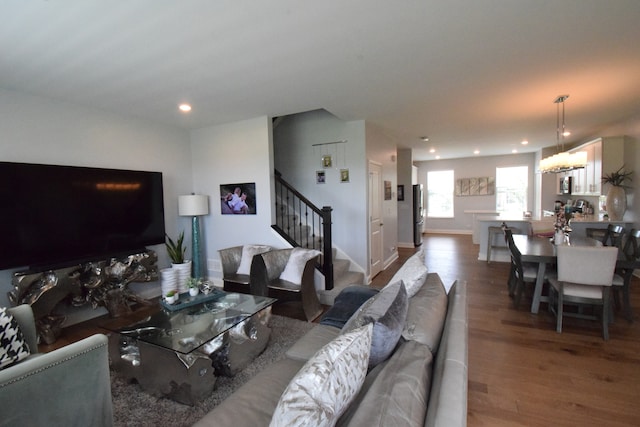 living room featuring a notable chandelier and wood-type flooring